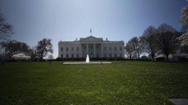 Beyaz Saray güneşli bir günde çiçek açan ağaçlar ve canlı yeşilliklerle çevrili olarak Washington DC 'de baharın güzelliğini gözler önüne seriyor..