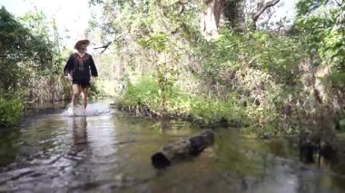 Gülümseyen bir kadın, Ometepe Adası 'ndaki Charco Verde Reserve' in bereketli patikalarını keşfediyor. Titreyen ormanlara ve dingin sulara dalmış..