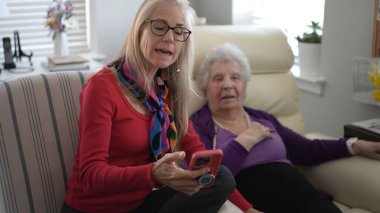 Yetişkin bir kız olarak iki nesil birbirine bağlanıyor. Yaşlı anne resimlerini telefonda gösteriyor. Yürekten bir anın tadını çıkarıyorlar, eski anıları yad ediyorlar..