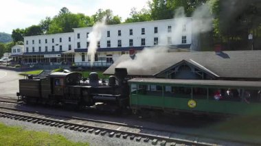 Düdük beyaz buhar üflerken hava kamerası trenin motoruna doğru ilerliyor..