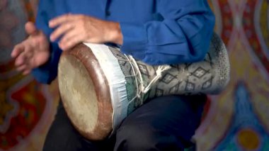 Balık derisi kafayla kil doumbek 'te ritim çalmak.