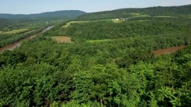 Batı Virginia ve Maryland 'deki Appalachian Dağları' ndaki çamurlu Potomac Nehri 'ni ortaya çıkarmak için ağaçların üzerinden yükselen hava manzarası.