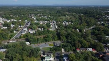 Enjoy aerial views of Martinsburg, West Virginia showcasing its charming architecture and vibrant autumn colors in a picturesque setting.