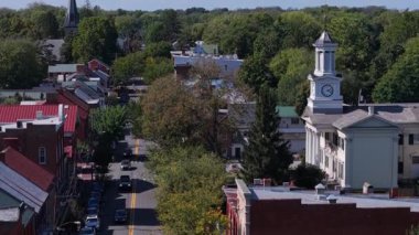 Explore the beauty of Shepherdstown, West Virginia with colorful autumn foliage and iconic landmarks under a clear blue sky.