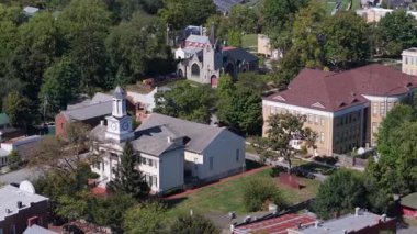 Aerial views capture the charm of Shepherdstown, West Virginia, showcasing colorful architecture and the serene Potomac River on a beautiful autumn afternoon.