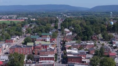 Experience the beauty of Charles Town, West Virginia with an aerial view of Main Street, the Jefferson County courthouse, and vibrant autumn colors in the sky.