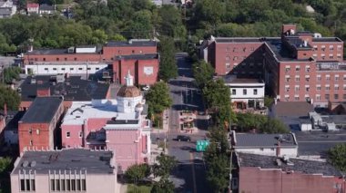 Experience the stunning aerial views of Martinsburg, West Virginia showcasing its historic streets and charming architecture on a bright autumn day.