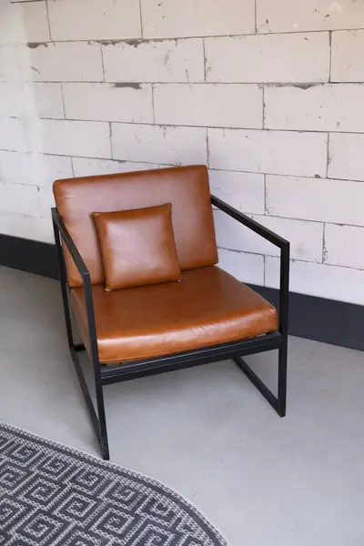 Beyaz tuğla duvarda siyah sandalye