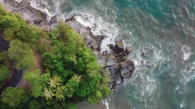 Deniz kıyısı kayaları ve trafik yollarının insansız hava aracı görüntüsü. Dalgalı denize yakın trafik yolu.