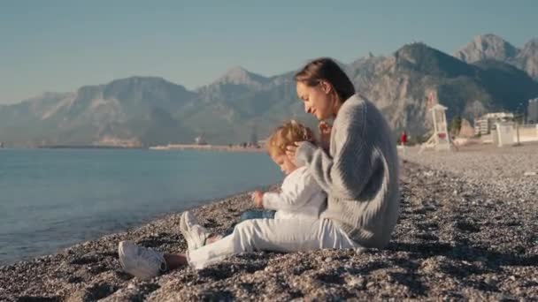 幸せな白人の家族が遊んでいて 日没時にビーチで楽しんでいます スローモーション 自由と旅行の概念 高品質4K映像 — ストック動画