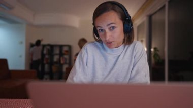 Hüsrana uğramış beyaz bir anne evde küçük bir çocukla çalışmaya çalışıyor.