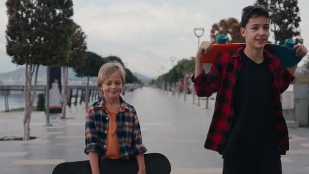Boys Carrying Skateboards Suburban Street — Vídeos de Stock