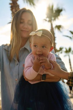 Photo of positive cheerful mom mommy lady playing cuddle with infant toddler on outside green public park. High quality photo
