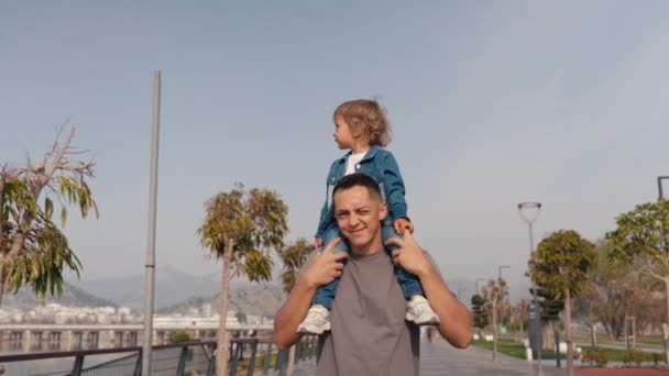 Father Son Walking City Sunset Two Year Old Kid Sitting — Stok Video