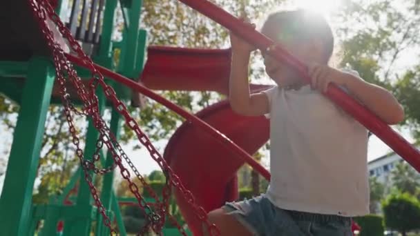 Child Climbs Grid Park Playground Hot Summer Day Rope Slide — Stock Video