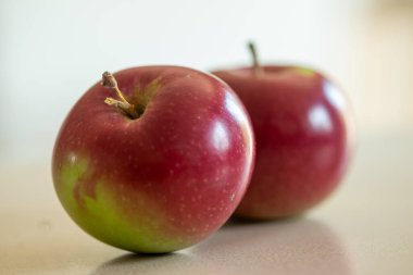 Two red apples freshly harvested during the month of september clipart