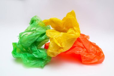 Beyaz zemin üzerinde sarı yeşil ve turuncu plastik torbalar