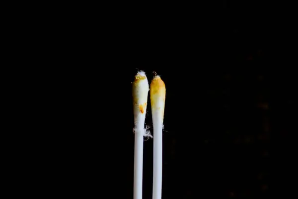 stock image Cotton swab. Ear stick. Earwax on black background