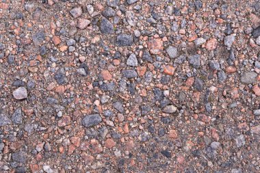 Küçük granit taşlı toprak yol. Tasarım için ince çakıl taşlarının arkaplan dokusu