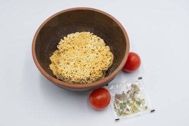 Instant pasta with herbs and spices in a bowl on a white background. clipart