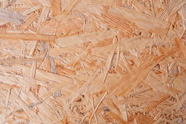 Kaba desenli kahverengi ahşap bir arka plan. OSB paneli. Ahşap yüzey.