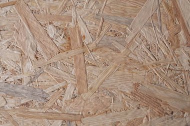 Kaba desenli kahverengi ahşap bir arka plan. OSB paneli. Ahşap yüzey.