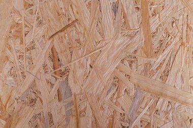 Kaba desenli kahverengi ahşap bir arka plan. OSB paneli. Ahşap yüzey.