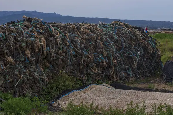 Fishing nets. Fishing ropes are stacked on the shore of the bay. Fishing gear.
