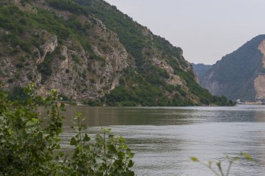 Nehir ve dağlarla dolu güzel bir manzara. Sırbistan ve Romanya sınırındaki Tuna Nehri manzarası. 
