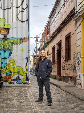 Valparaiso şehrinde Şili 'ye hayran olan ve yürüyen genç bir gezgin. Gezgin renkli caddelerde yürüyor