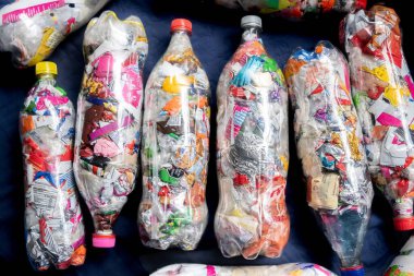 Geri dönüşüm ve sürdürülebilirlik. Paketlerle dolu plastik şişeler. Aşk şişeleri. Aşkın şişeleri. Ekolojik tuğlalar. Ecoladrillos