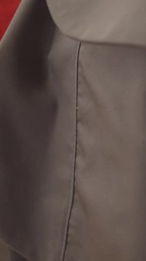 Kırmızı, gri ve mavi kumaşların dokularını ve dikişlerini gösteren makro çekim, malzeme ayrıntılarını vurgulamak ve dikiş işi.