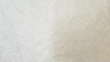 Dönüyor ve gerçek beyaz kağıt dokusu arka planında zumluyor. düz beyaz buruşmuş kağıt arkaplan döngüsü döndürme