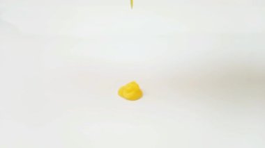 Beyaz arkaplana dökülen sarı sıvı doku, şampuan, temizleyici, kozmetik veya cilt ürünü