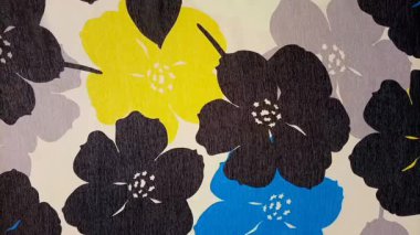 Hareket etmeyi durdur. Tekstil, doku, kalın, estetik. Siyah, mavi ve sarı çiçeklerle sadeleştirilmiş, gri ve beyaz olmayan arkaplan.