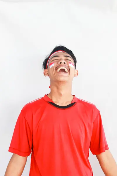 stock image Portrait of asian man isolated on white background. Male model laughing happily in celebration studio photo shoot for Indonesian independence day.