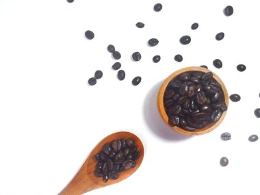  Roasted coffee bean on small wooden bowl and spoon isolated on white background with copy space clipart