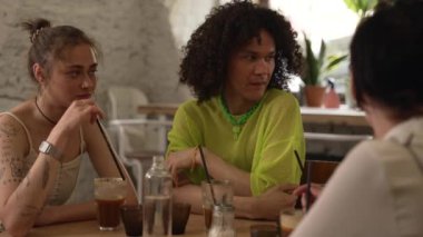 4K homoseksüel insanlar barda içer ve konuşurlar. Güzel lezbiyen kadınlar, gülümseyerek konuşan, alkol alan, kutlama yapan ve masada oturan eşcinsel erkekler. Çift ırklı olmayan çok ırklı arkadaşlar