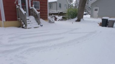 Arka bahçe, garaj yolu ve ev kar fırtınasından sonra karla kaplı.
