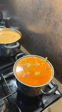 Etli ve limonlu otlu erken dönem rendang fırında kaynıyor. Rendang, Batı Sumatra, Endonezya 'dan gelen zengin ve lezzetli bir et yemeği.