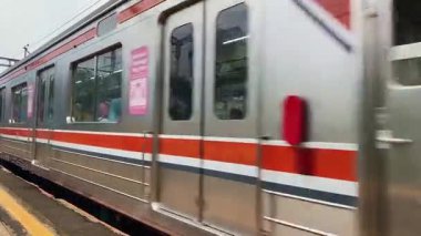Bir tren istasyonundaki göz seviyesinde statik çekim KRL banliyö treninin soldan geldiğini gösteriyor. Yüksek kaliteli FullHD görüntüler