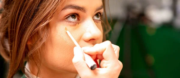 Beautiful Young Brunette Woman Receiving Makeup Stick Concealer Her Face — Stock Photo, Image