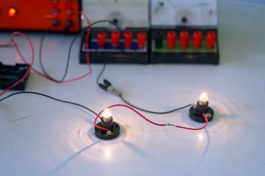 Öğrenciler temel elektrik devreleri üzerinde deneyler yapıyorlar. Fen sınıfı kavramı, fen bilgisi, bilim becerileri, öğrenme, bilim deneyleri.                               