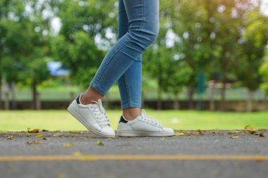 steps of Asian women While walking on the streets of the park, concept steps towards the goal. soft and selective focus.	                               
