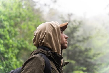 Serin bir sonbahar gününde ormanda yürüyüş yapan bir adam. Doğada spor kavramı