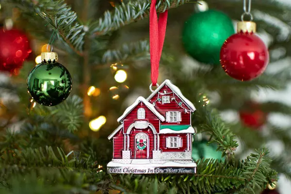 stock image Buying first home concept. House ornament on a Christmas tree. First year in a new house. Buying first real estate. 