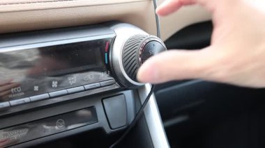 Erkekler, arabanın gösterge panelindeki iklim kontrolündeki ısıyı ayarlıyorlar