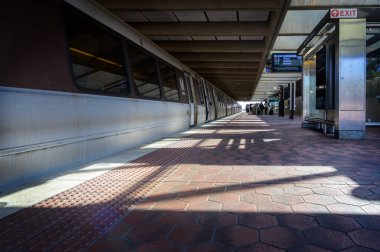 Side of train car at station platform, East Falls Church metro station, Arlington, Virginia. clipart