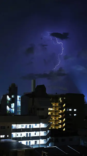 stock image Fierce lightning bolts popping out from low thunderclouds: Vertical landscape