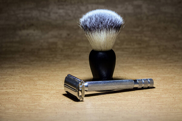 Concept photo of a shaving razor and shaving brush